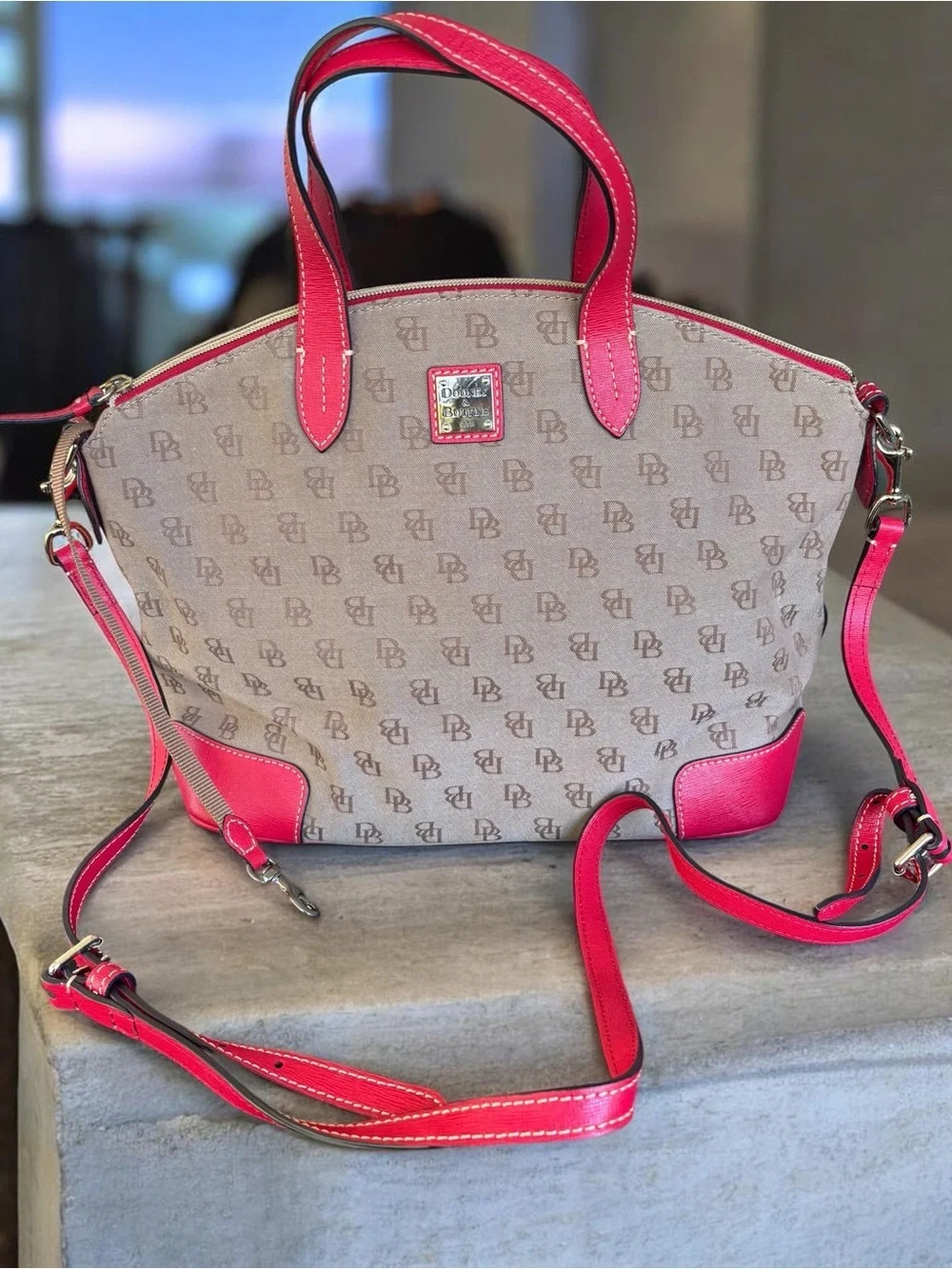 Dooney & Bourke Signature monogram satchel features vibrant pink leather trim